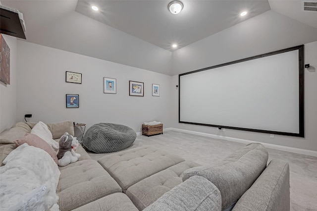 carpeted cinema room featuring lofted ceiling