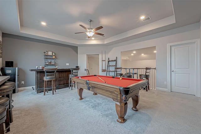 game room featuring a raised ceiling, bar, light colored carpet, and pool table