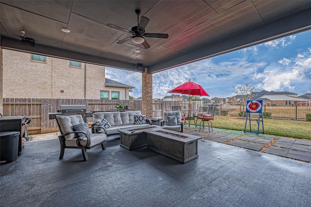 view of patio featuring ceiling fan, an outdoor living space with a fire pit, and grilling area