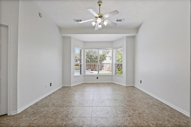 unfurnished room featuring light tile patterned flooring, ceiling fan, and a textured ceiling