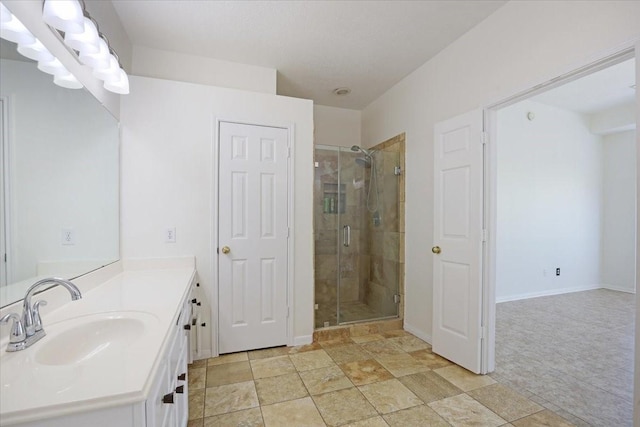 bathroom featuring vanity and an enclosed shower