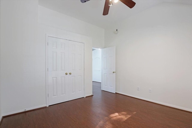 unfurnished bedroom with ceiling fan, dark hardwood / wood-style floors, and a closet