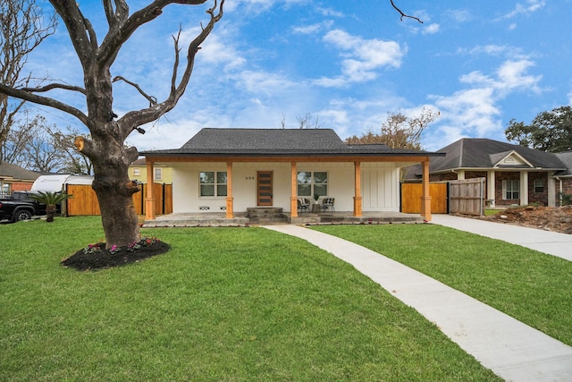 ranch-style home with covered porch and a front lawn