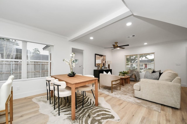 dining space featuring beam ceiling, ornamental molding, light hardwood / wood-style floors, and ceiling fan