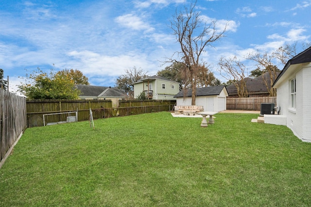 view of yard with cooling unit, a storage shed, and a patio