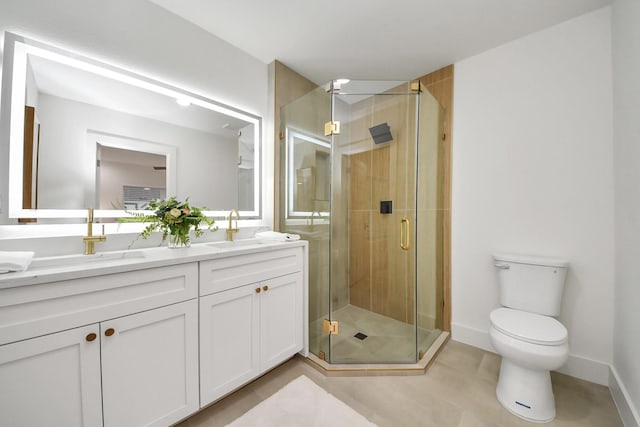 bathroom featuring tile patterned flooring, vanity, toilet, and walk in shower