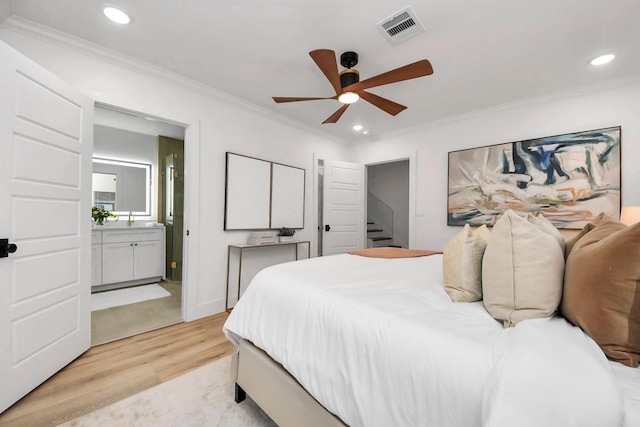 bedroom with ceiling fan, ornamental molding, connected bathroom, and light hardwood / wood-style floors