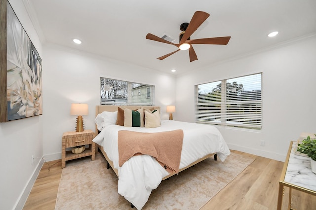 bedroom with crown molding, ceiling fan, and light hardwood / wood-style flooring