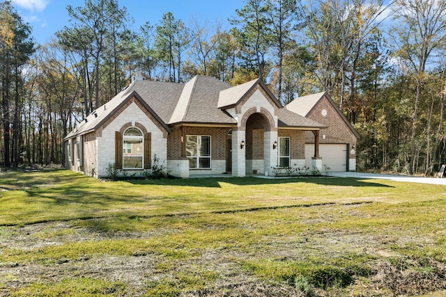 view of front of house featuring a garage and a front lawn