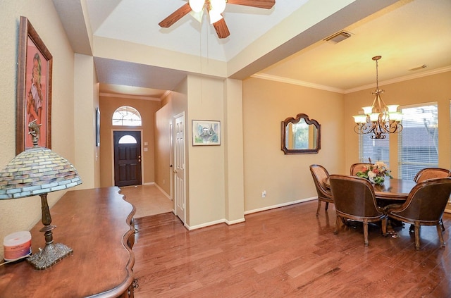 entryway featuring hardwood / wood-style floors, crown molding, ceiling fan with notable chandelier, and a wealth of natural light