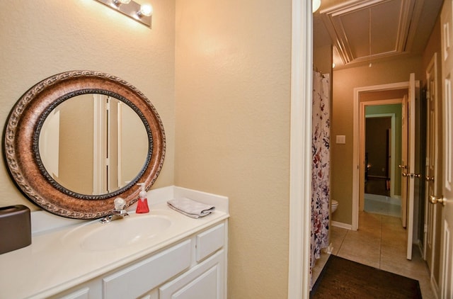 bathroom featuring vanity, tile patterned floors, and toilet