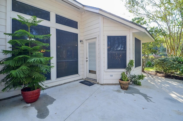 entrance to property featuring a patio