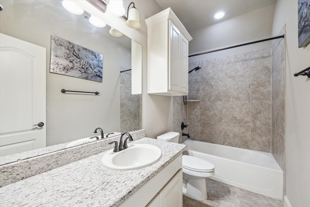 full bathroom with vanity, tiled shower / bath combo, tile patterned floors, and toilet