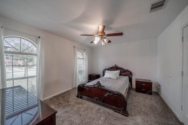 bedroom with multiple windows, carpet floors, and ceiling fan