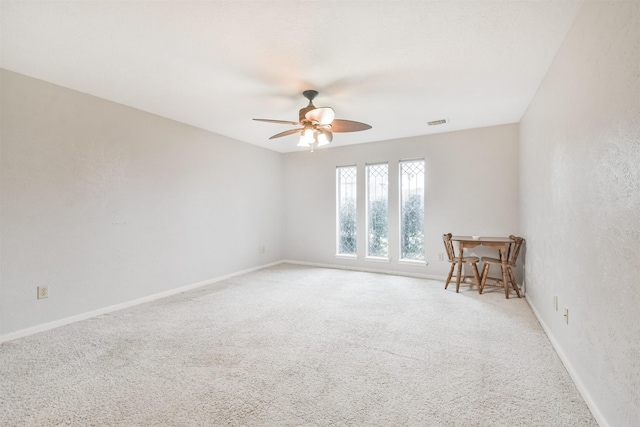 spare room with carpet flooring and ceiling fan