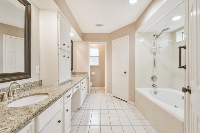 full bathroom with vanity, tiled shower / bath, tile patterned floors, and toilet