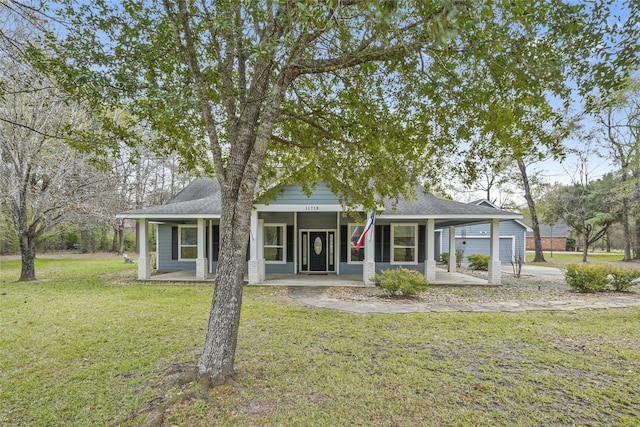 view of front of house with a garage, covered porch, and a front lawn