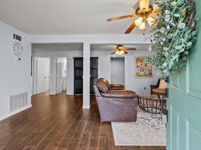 living area featuring dark wood-style floors, ceiling fan, and visible vents