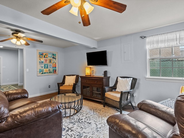 living room featuring a ceiling fan, beam ceiling, electric panel, and baseboards