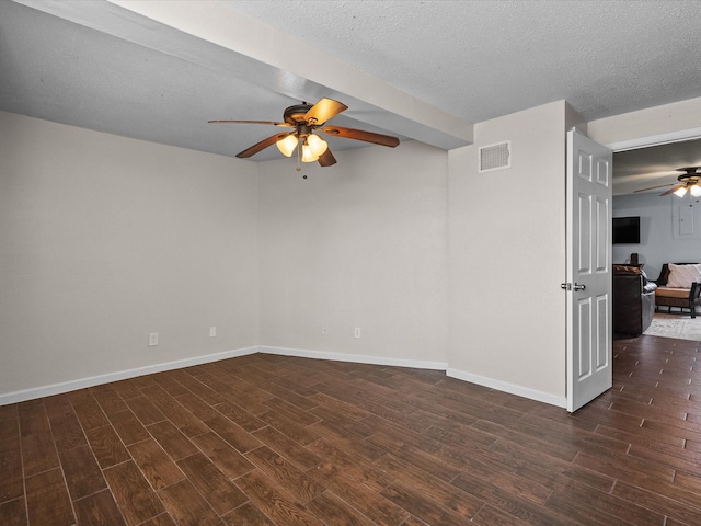 unfurnished room with wood finished floors, visible vents, and baseboards