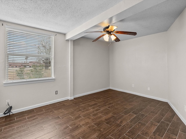 empty room featuring a textured ceiling, wood finished floors, a ceiling fan, and baseboards