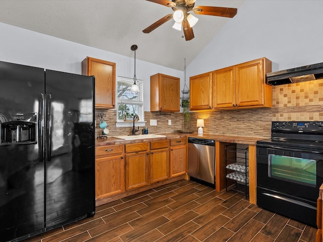 kitchen with a sink, vaulted ceiling, range hood, wood tiled floor, and black appliances