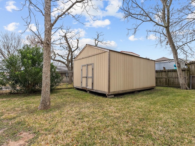 view of shed featuring fence