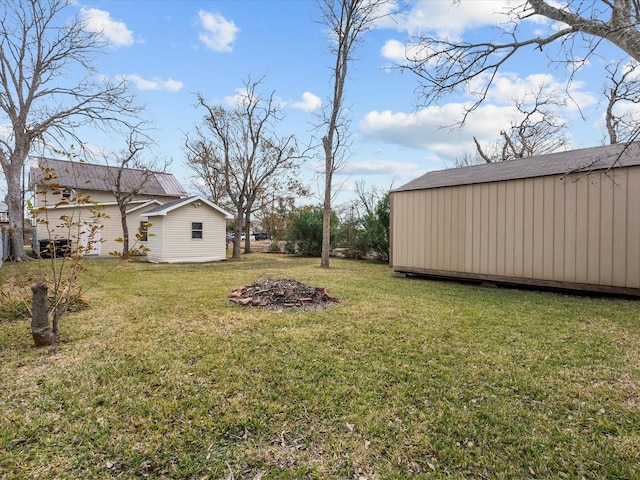 view of yard with a storage shed and an outbuilding