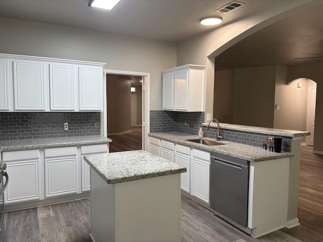 kitchen with white cabinetry, dishwasher, sink, and a kitchen island