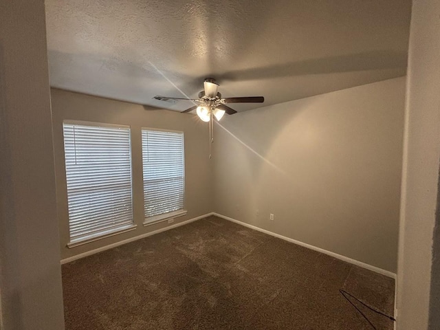 carpeted empty room with ceiling fan, lofted ceiling, and a textured ceiling