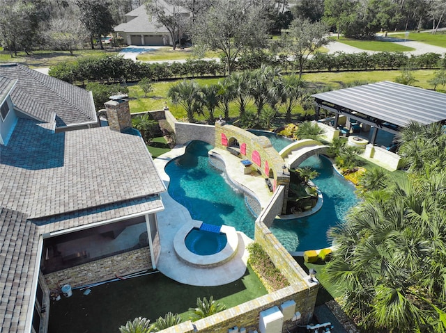 view of swimming pool with an in ground hot tub