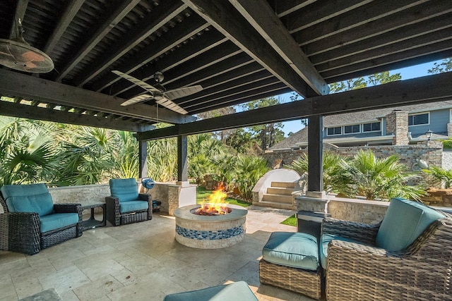 view of patio / terrace featuring ceiling fan and an outdoor fire pit