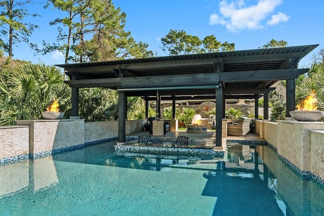 view of pool with a gazebo and an outdoor fire pit