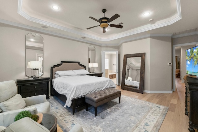 bedroom with ornamental molding, a raised ceiling, and light hardwood / wood-style floors