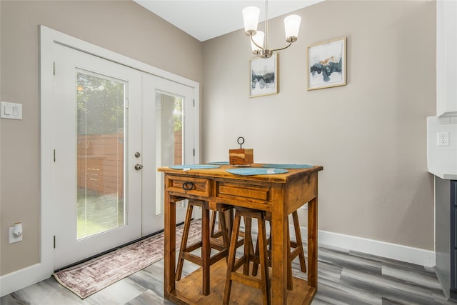 dining room featuring plenty of natural light, a chandelier, and french doors