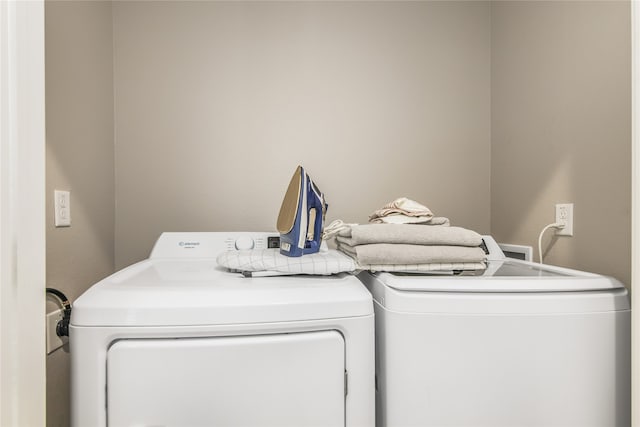 laundry area with washing machine and clothes dryer