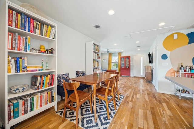 dining room featuring ceiling fan, light hardwood / wood-style floors, and built in features