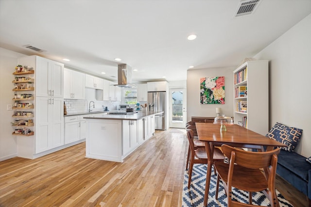 dining room featuring sink and light hardwood / wood-style flooring