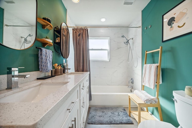 full bathroom with shower / tub combo with curtain, vanity, and toilet