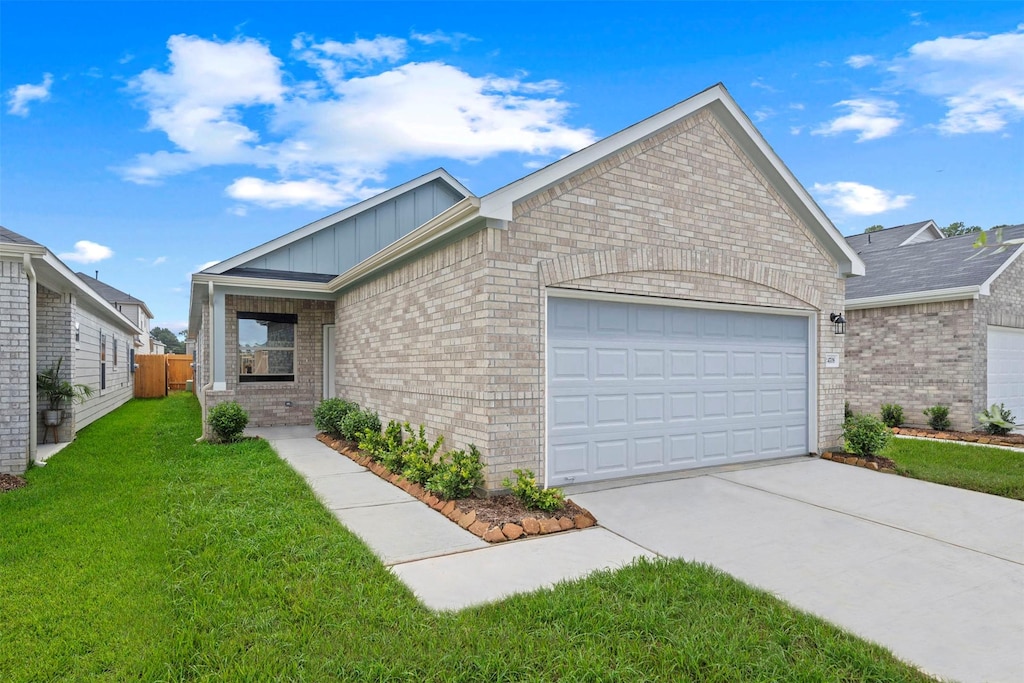 view of front of property with a garage and a front lawn