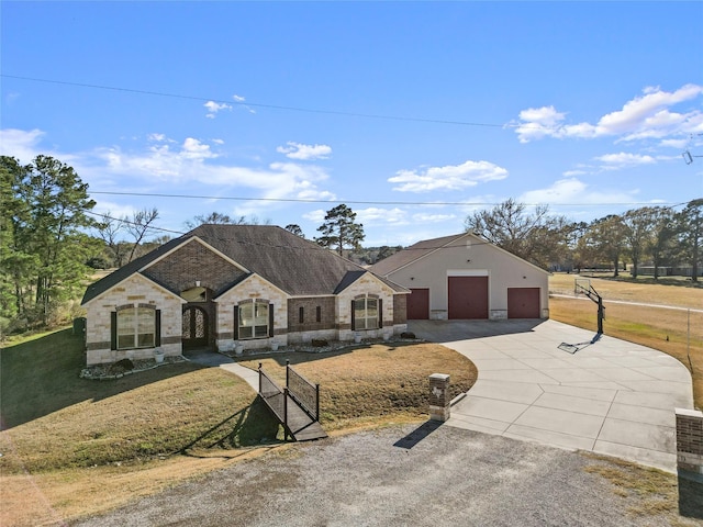 view of front of home with a garage and a front lawn