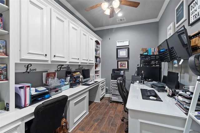 office featuring built in desk, ornamental molding, and ceiling fan