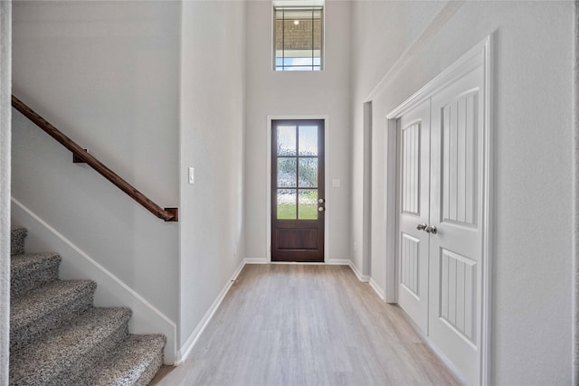 entrance foyer with light hardwood / wood-style flooring and a high ceiling