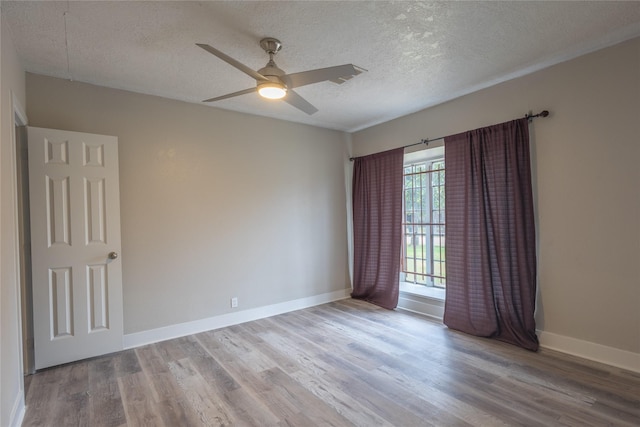 spare room featuring ceiling fan, hardwood / wood-style floors, and a textured ceiling