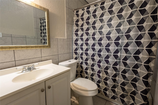 bathroom featuring vanity, toilet, a shower with shower curtain, and tile walls