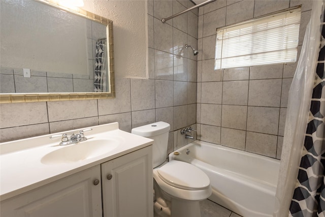 full bathroom featuring vanity, tile walls, shower / bath combination with curtain, and toilet