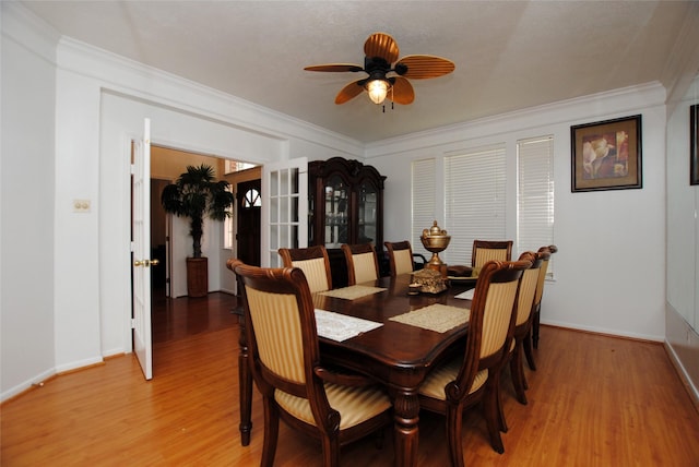 dining area featuring ceiling fan, ornamental molding, and light hardwood / wood-style floors