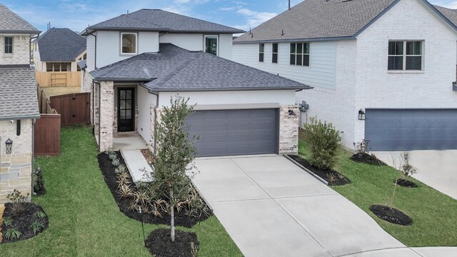 view of front facade with a garage and a front lawn