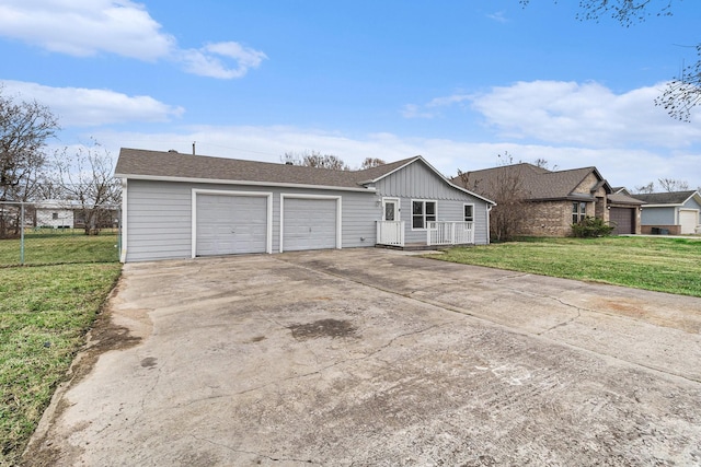 ranch-style home featuring a garage and a front lawn