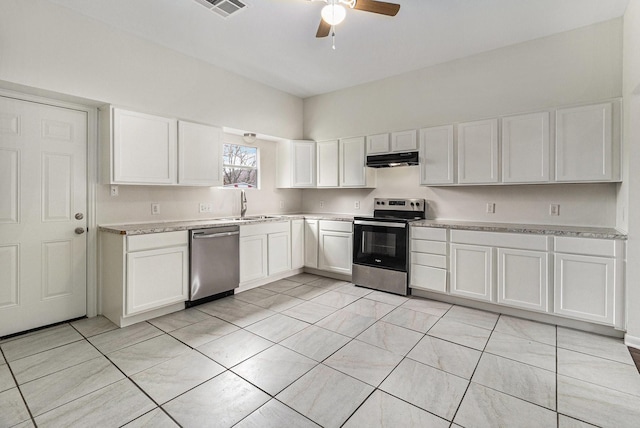 kitchen with light tile patterned flooring, appliances with stainless steel finishes, sink, white cabinets, and ceiling fan